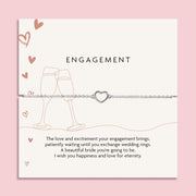 Letterbox Love poem card with brown celebration illustrations and a meaningful poem. Around the card is a silver-plated hollow heart bracelet, an elegant gift for an engagement