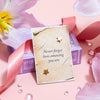 A pair of star-shaped gold earrings displayed on a vintage-inspired paper card with the uplifting message 