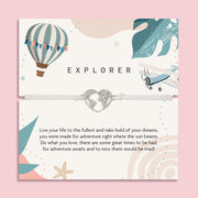 Letterbox Love 'Explorer' travel-themed bracelet – silver heart world map charm on a white cord, displayed on an adventure-inspired card with a hot air balloon, airplane, and uplifting message. Perfect gift for travellers, backpackers, graduates or anyone chasing their dreams. A thoughtful letterbox gift for wanderlust and new journeys.