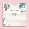 Letterbox Love 'Explorer' travel-themed bracelet – silver heart world map charm on a white cord, displayed on an adventure-inspired card with a hot air balloon, airplane, and uplifting message. Perfect gift for travellers, backpackers, graduates or anyone chasing their dreams. A thoughtful letterbox gift for wanderlust and new journeys.