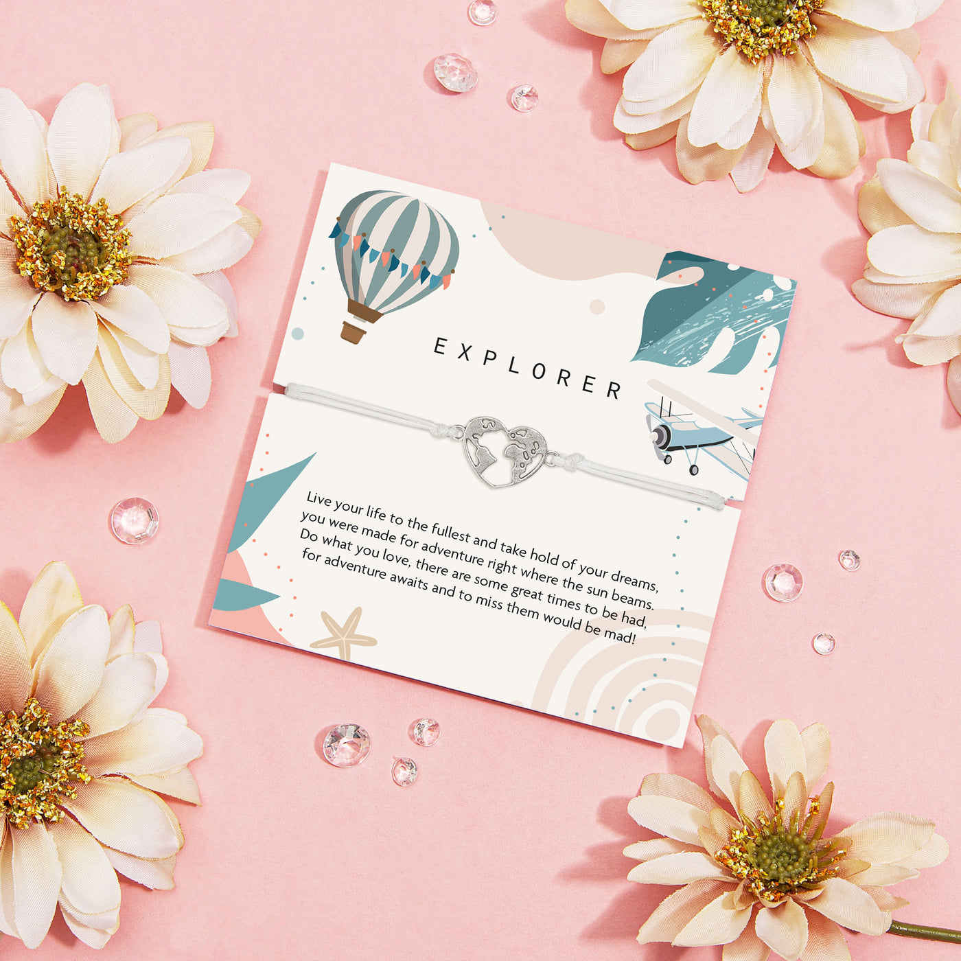 Card with 'Explorer' design surrounded by flowers on a pink background. A cute travel bracelet to wish luck to a friend