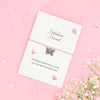 Fabulous Friend bracelet with silver butterfly charm on pink cord, displayed on an A6 plantable seeded card made from recycled cotton, featuring a friendship poem and soft butterfly design.