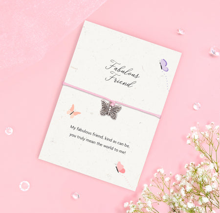 Fabulous Friend bracelet with silver butterfly charm on pink cord, displayed on an A6 plantable seeded card made from recycled cotton, featuring a friendship poem and soft butterfly design.