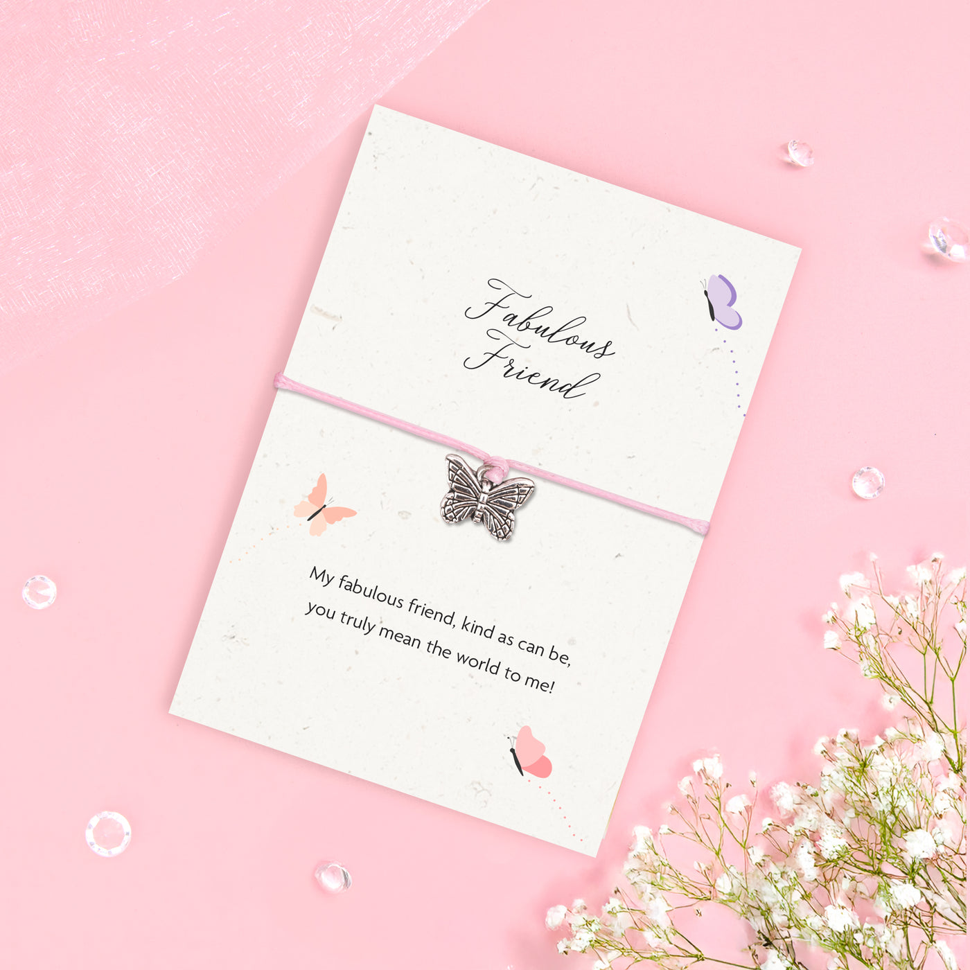 Fabulous Friend bracelet with silver butterfly charm on pink cord, displayed on an A6 plantable seeded card made from recycled cotton, featuring a friendship poem and soft butterfly design.