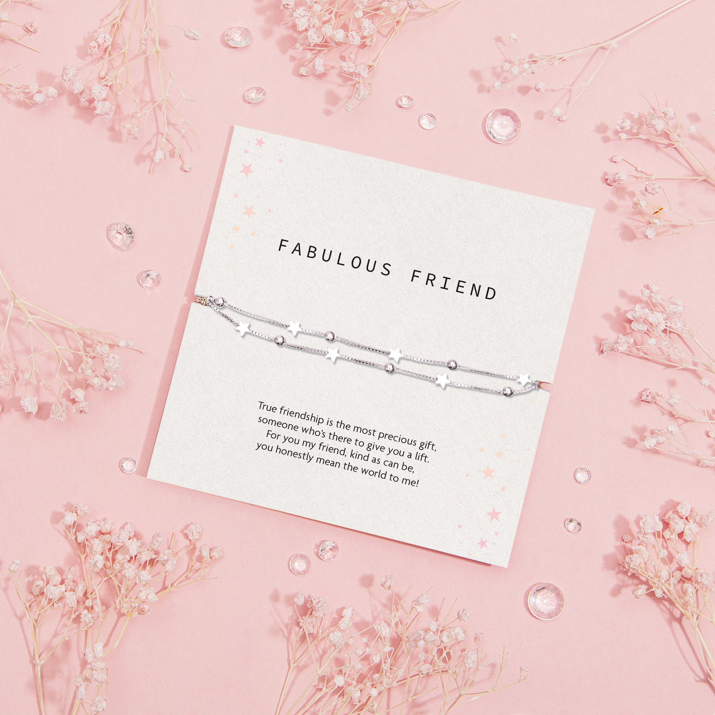 Silver star bracelet on a 'Fabulous Friend' card with floral decorations on a pink background. A jewellery gift for women under £20