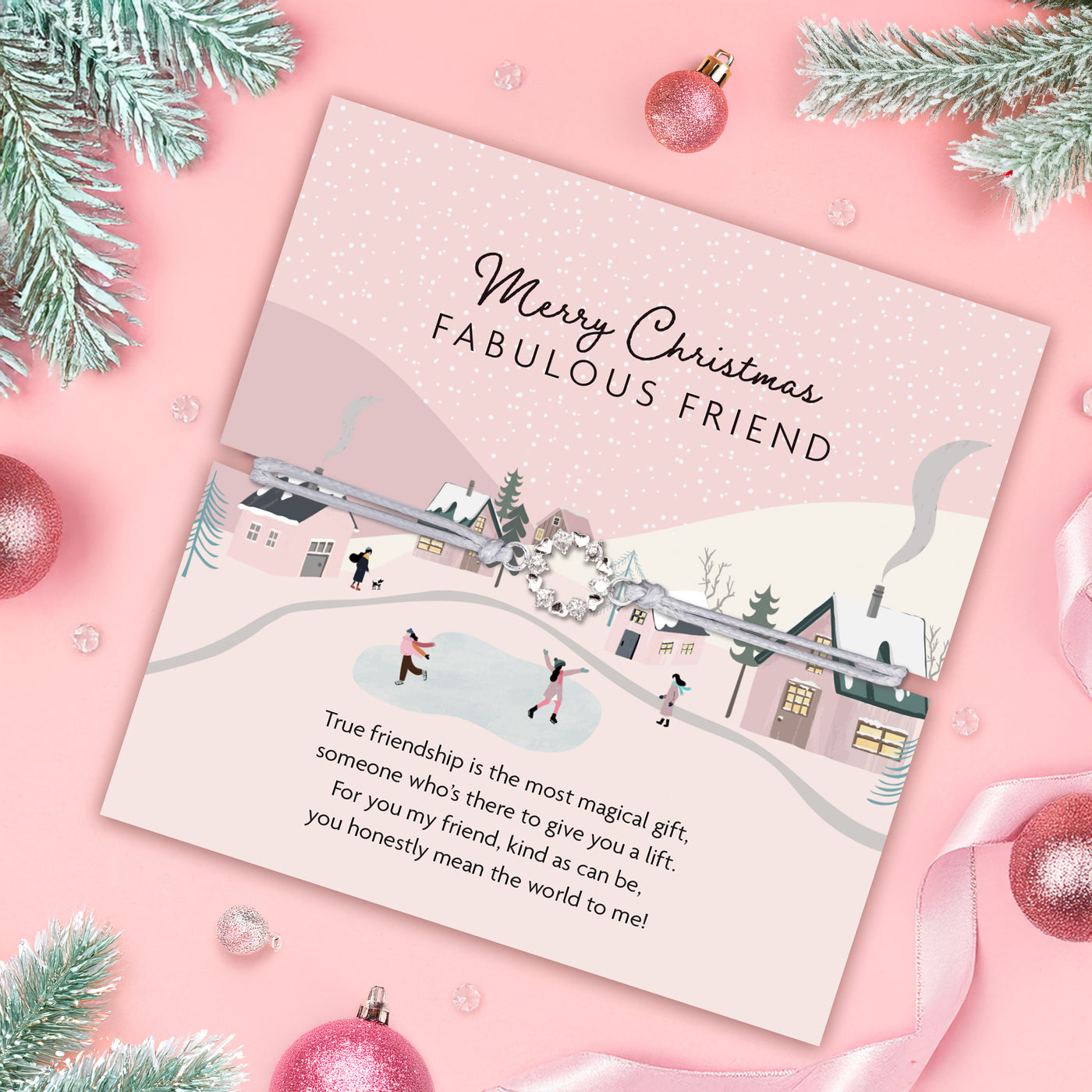 Christmas card with festive design and text on a pink background with Christmas decorations. An affordable bracelet for a friend at Christmas