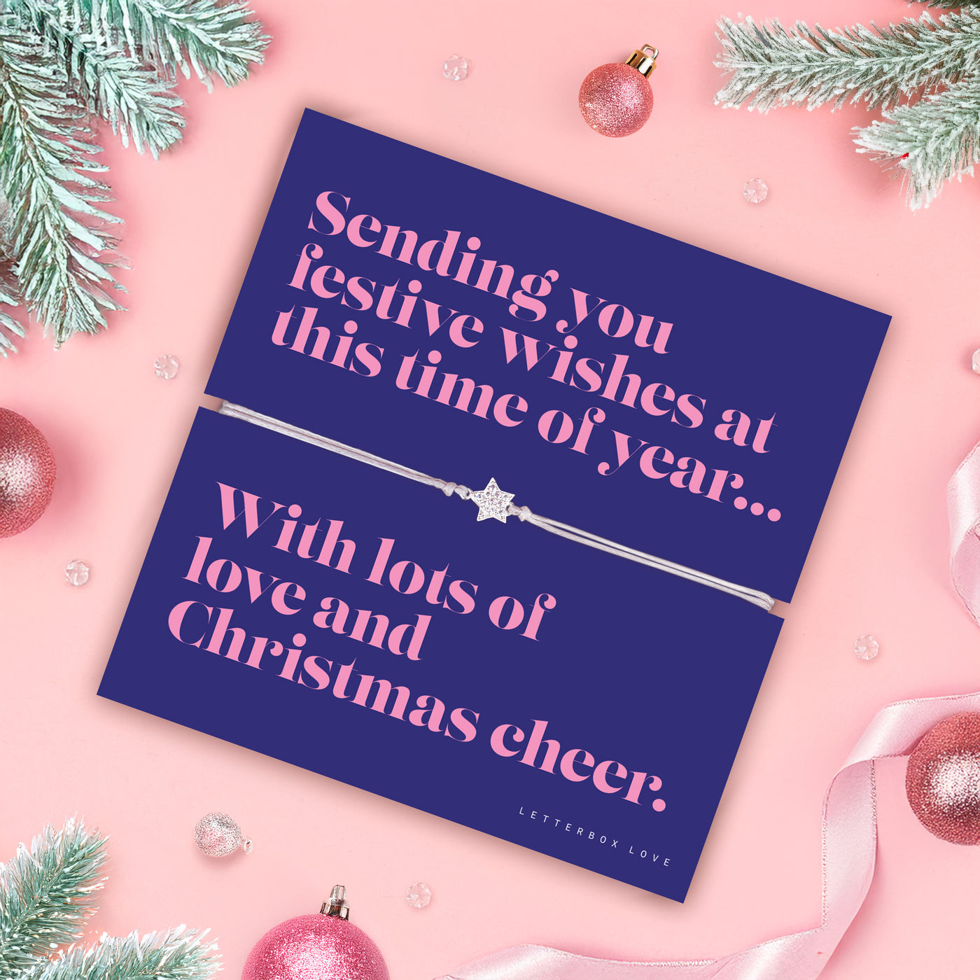 Christmas card with festive message on a pink background with decorations. An affordable bracelet for a friend this Christmas