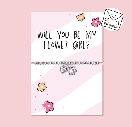 Children’s silver-plated flower girl proposal bracelet with heart and flower charms displayed on a pink “Will You Be My Flower Girl?” card.