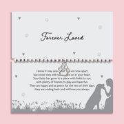 Silver beaded stretch bracelet with paw print charm on “Forever Loved” pet memorial poem card, sympathy gift for dog or cat loss.