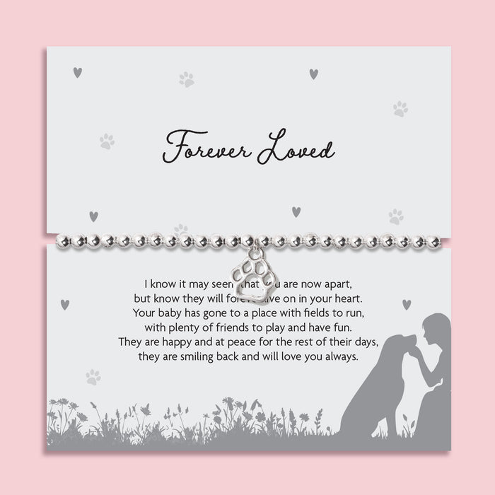 Silver beaded stretch bracelet with paw print charm on “Forever Loved” pet memorial poem card, sympathy gift for dog or cat loss.