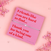 Friendship bracelet for a best friend on a pink and red card. Cute star bracelet on grey string.