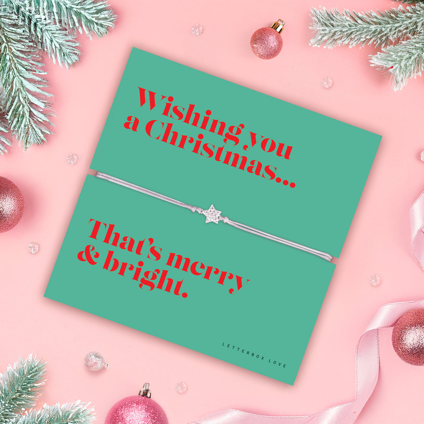Christmas poem card with an elegant bracelet and festive decorations on a pink background