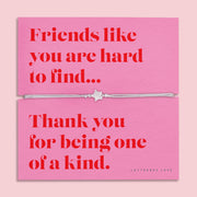 Friendship bracelet for a best friend on a pink and red card. Cute star bracelet on grey string.