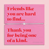 Friendship bracelet for a best friend on a pink and red card. Cute star bracelet on grey string.