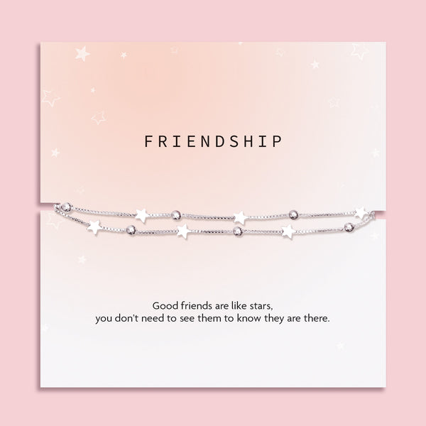 Double-chain silver star and bead bracelet mounted on a blush pink and white sentiment card that reads: "Good friends are like stars, you don’t need to see them to know they are there." Featuring the title "FRIENDSHIP" and Letterbox Love branding.