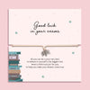 Good luck exam bracelet with open book charm on adjustable cord, displayed on a motivational exam gift card with poem, student encouragement gift