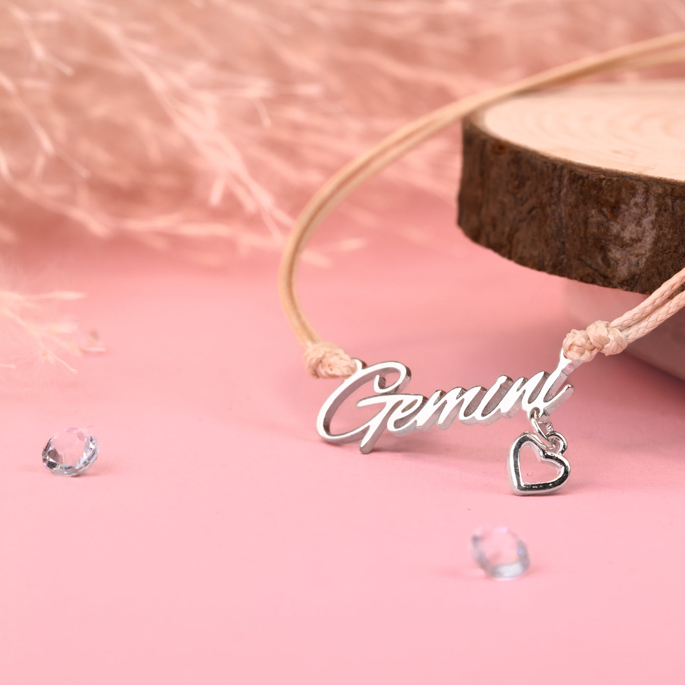 Necklace with 'Gemini' pendant on a pink background. Affordable birthday gift for a Gemini. Zodiac bracelet under £20.