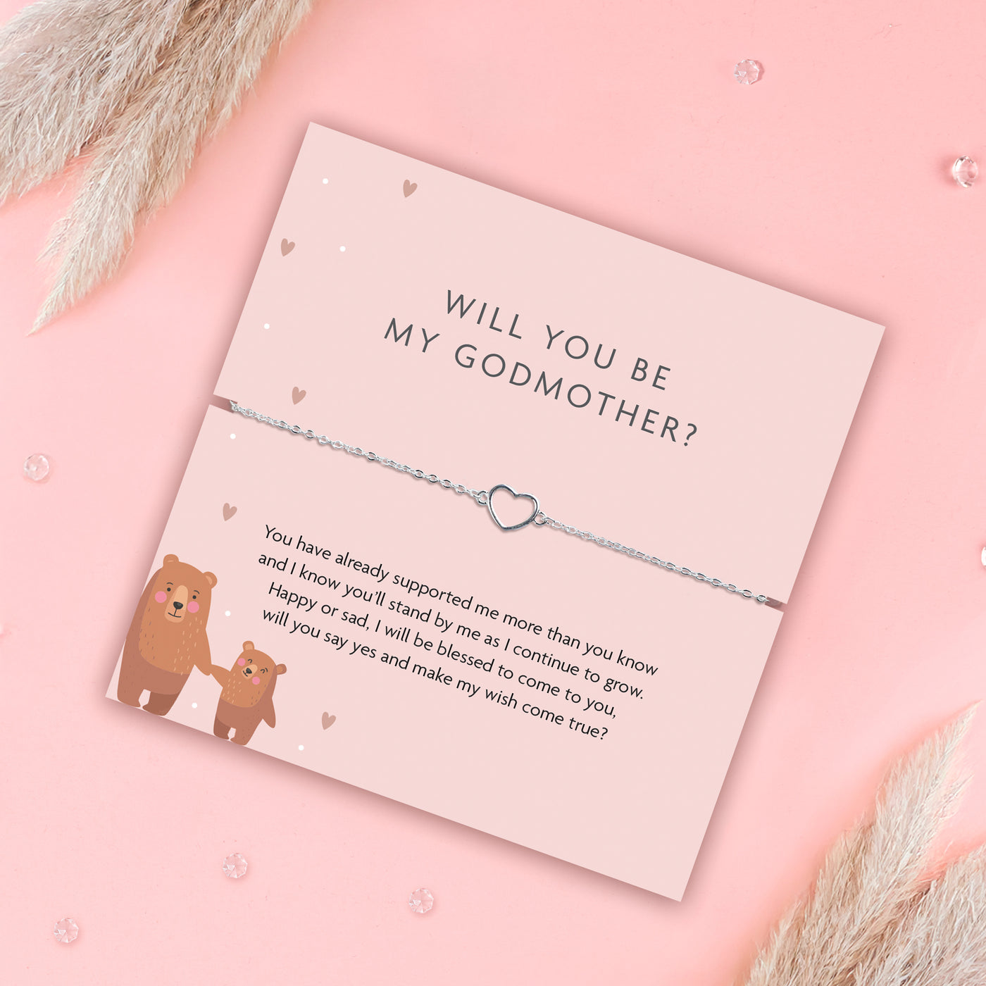 Pink godmother proposal card with silver heart bracelet and poem, featuring two illustrated bears holding hands and surrounded by delicate hearts on a soft pink background.