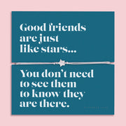 A silver-plated star charm bracelet on an adjustable cord, displayed on a teal backing card with the message: "Good friends are just like stars… You don’t need to see them to know they are there." Surrounded by blue flowers on a soft pink background. Perfect for gifting.