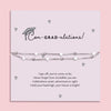 Silver star graduation bracelet on a pale grey card with a mortarboard and poem, titled “Con-GRAD-ulations!” – a perfect gift for her special day.