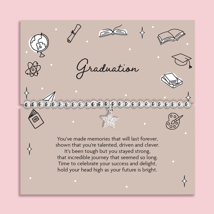 Graduation-themed card with decorative elements and a message on a pink background. The bracelet is a silver-plated star bracelet