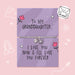 A silver charm bracelet displayed on two lavender gift cards with handwritten-style text and cute doodles, set against a light pink background. One card reads 'To MY GRANDDAUGHTER.