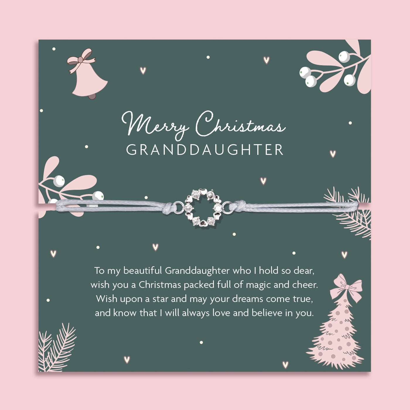 Merry Christmas Granddaughter bracelet featuring a silver wreath charm on an adjustable cord, presented on a festive dark green card with bells, mistletoe, fir branches, and a Christmas tree. Includes a soft white pouch for gifting and safekeeping. A sentimental Christmas jewellery gift for granddaughters of all ages, perfect as a stocking filler, Christmas morning surprise, or heartfelt keepsake from grandparents to celebrate love and family at Christmas.