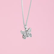 Butterfly charm bracelet on a pink background