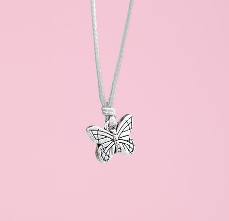 Butterfly charm bracelet on a pink background