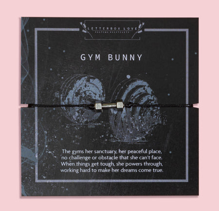 Gym Bunny bracelet featuring a silver-tone dumbbell charm on a black adjustable cord, displayed on a motivational gym-themed card with the message about strength, resilience, and powering through challenges. This fitness bracelet is the perfect gift for gym lovers, workout enthusiasts, personal trainers, and women who love weightlifting or staying active. A unique piece of fitness jewellery and an inspiring keepsake for birthdays, Christmas, or everyday motivation.