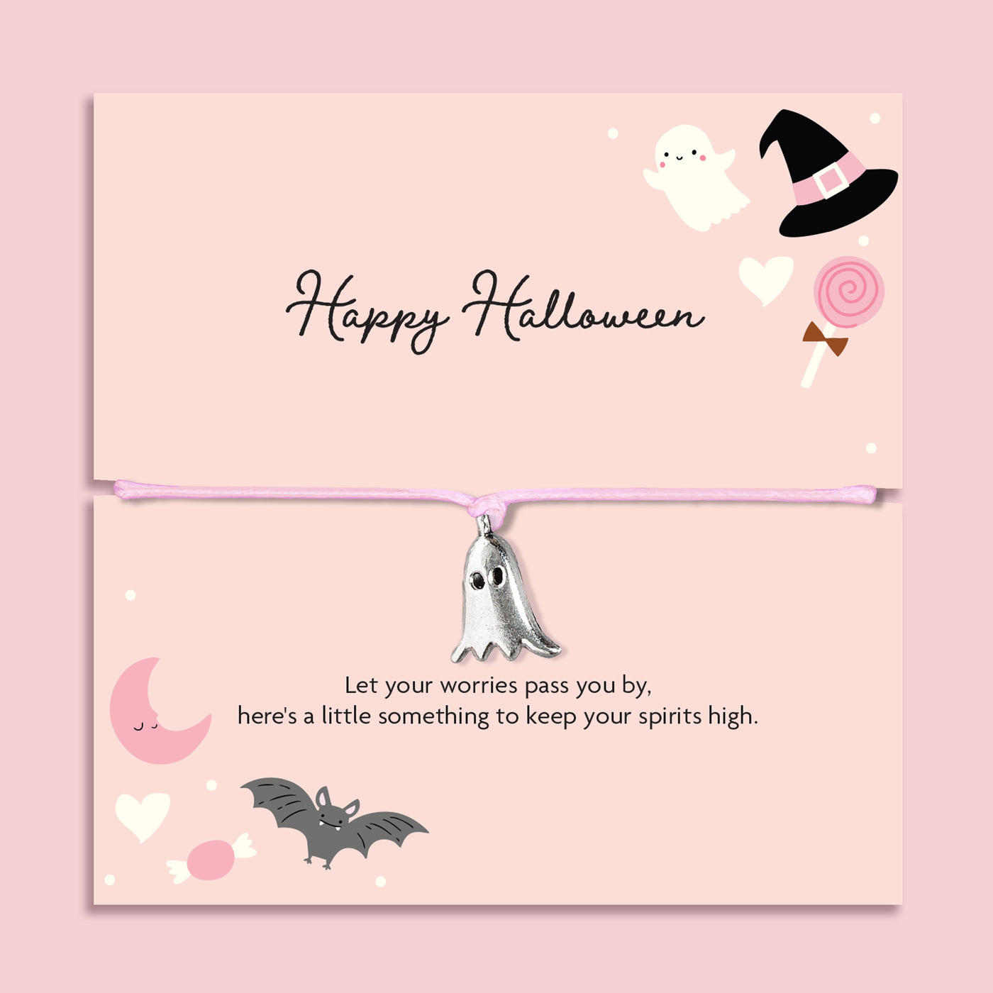 Pink adjustable cord Halloween bracelet with silver plated ghost charm displayed on a pastel pink Happy Halloween sentiment card with spooky ghost, bat, moon and witch hat illustrations.