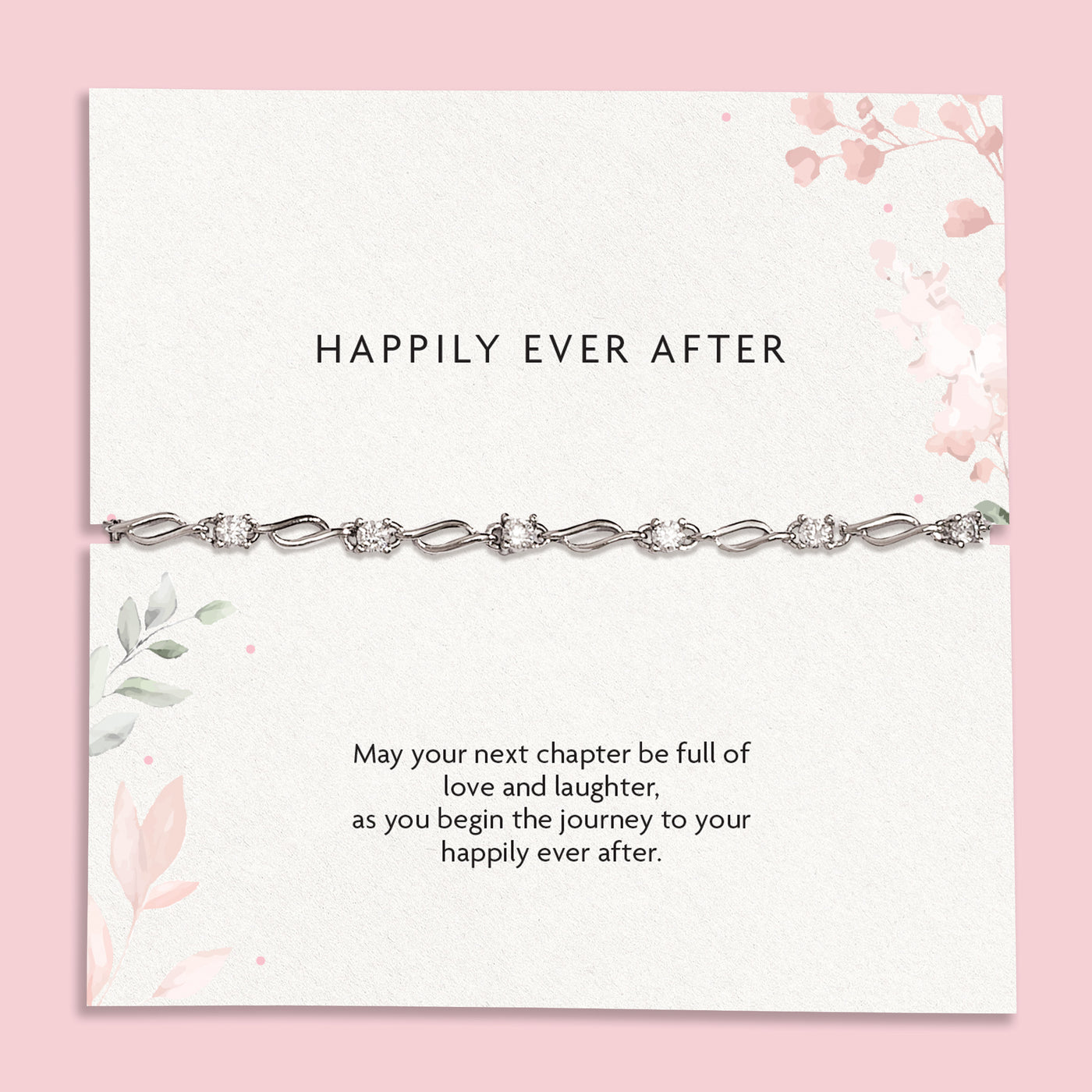 A delicate silver chain bracelet with clear rhinestones displayed on a white card with pink floral accents and the text 'HAPPILY EVER AFTER' and a sentimental message below, set against a solid pink background.