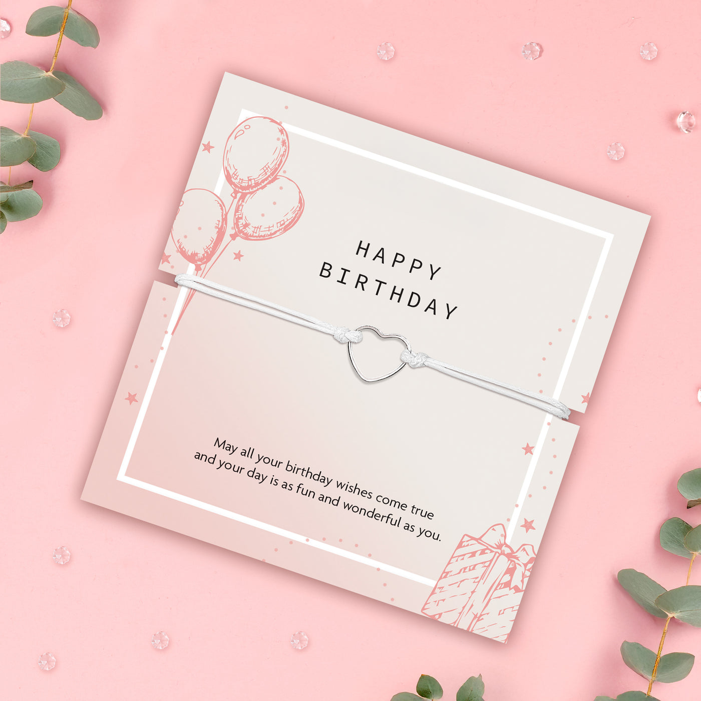 Letterbox Love happy birthday bracelet gift – dainty heart charm on a white cord, presented on a pastel pink birthday card with a sweet message, perfect affordable jewellery gift for her, friend or teen. Happy Birthday gifts under £10.