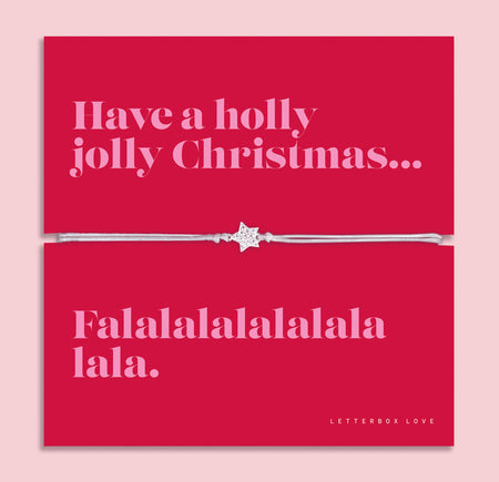 Holly Jolly Christmas star bracelet featuring a sparkling cubic zirconia star charm on an adjustable cord, presented on a bold red Christmas card with the message “Have a holly jolly Christmas… Falalalalalalala.” Arrives beautifully gift wrapped for Christmas gifting. A fun and thoughtful Christmas jewellery gift, perfect as a stocking filler, Secret Santa present.