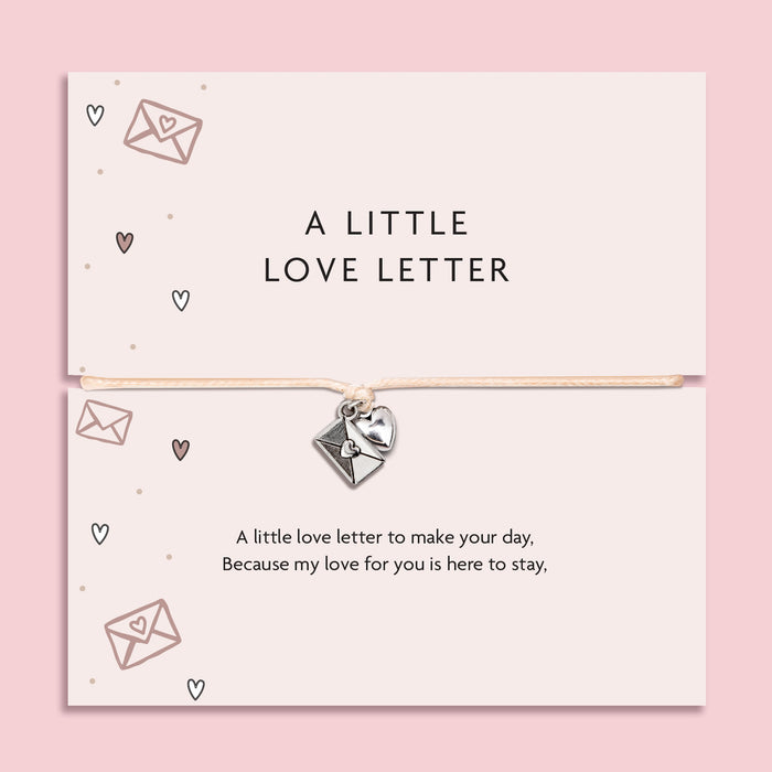 Bracelet with heart charm on a card labeled 'A Little Love Letter' against a pink background. A gift to say 'I love you'
