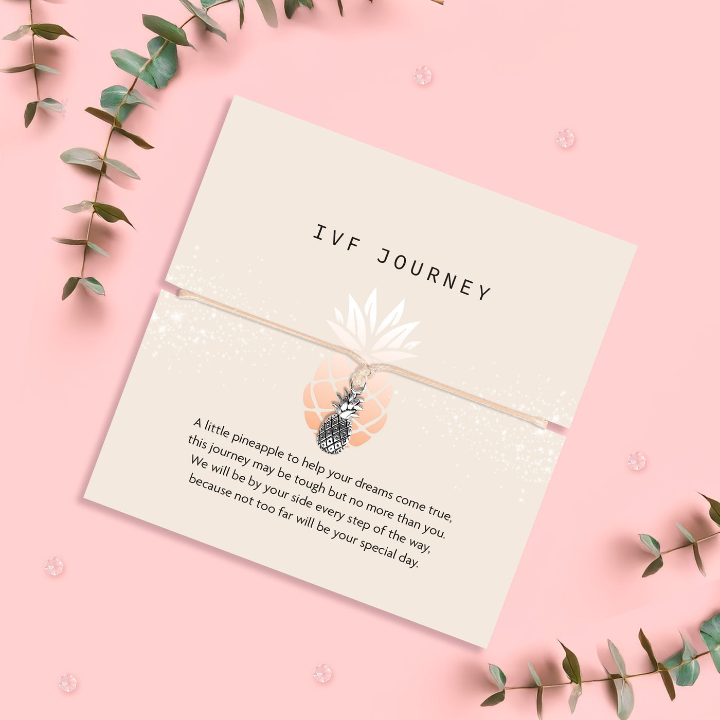 Pineapple charm bracelet for IVF journey, presented with a heartfelt sentiment card offering encouragement and support. The design includes a small silver pineapple charm on a beige cord with a meaningful message.