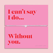 Silver heart charm bracelet on a soft grey adjustable cord, displayed on a vibrant pink sentiment card reading "I can't say I do... Without you." A meaningful bridesmaid proposal bracelet and wedding keepsake gift for a maid of honour, bridal party member, sister or best friend.