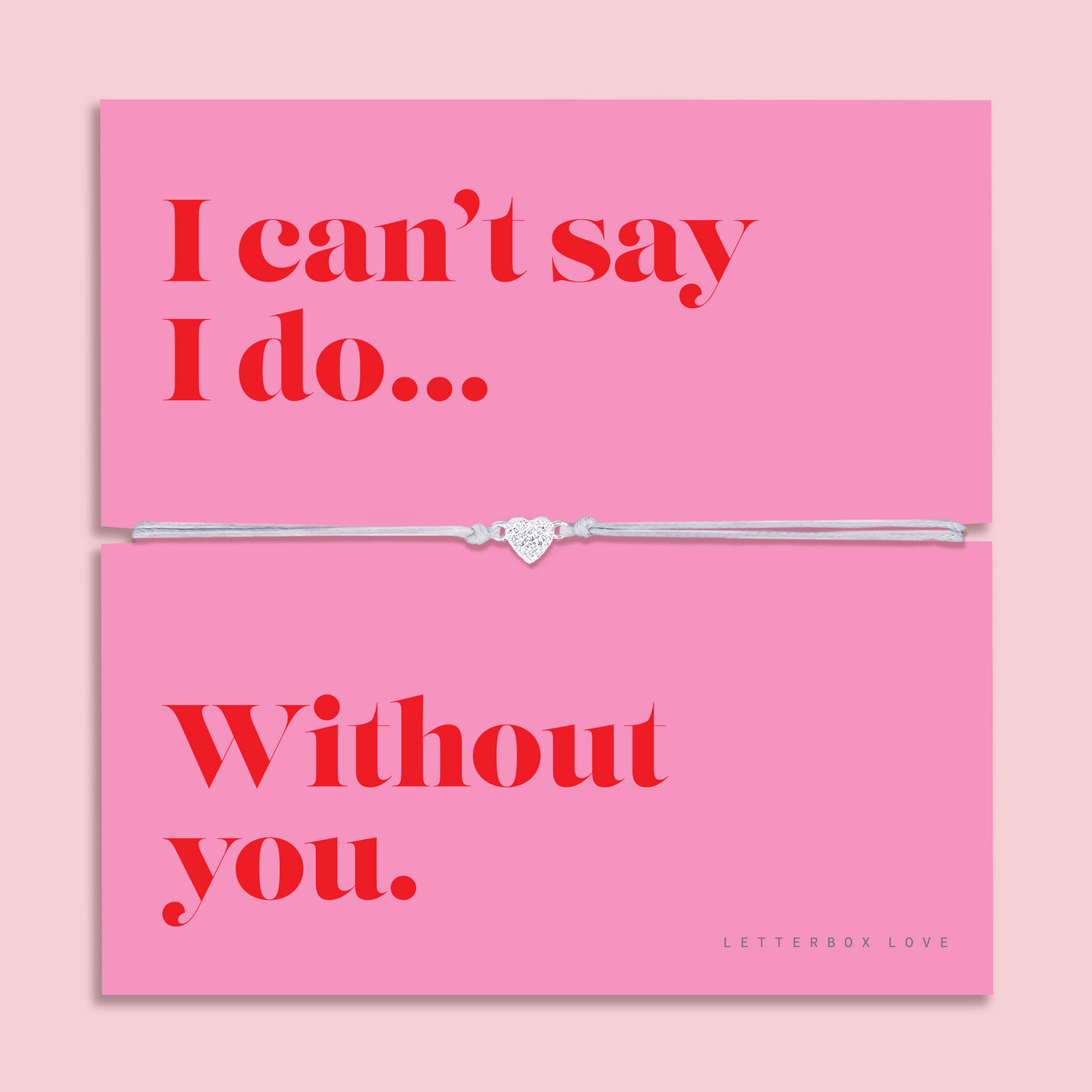 Silver heart charm bracelet on a soft grey adjustable cord, displayed on a vibrant pink sentiment card reading 