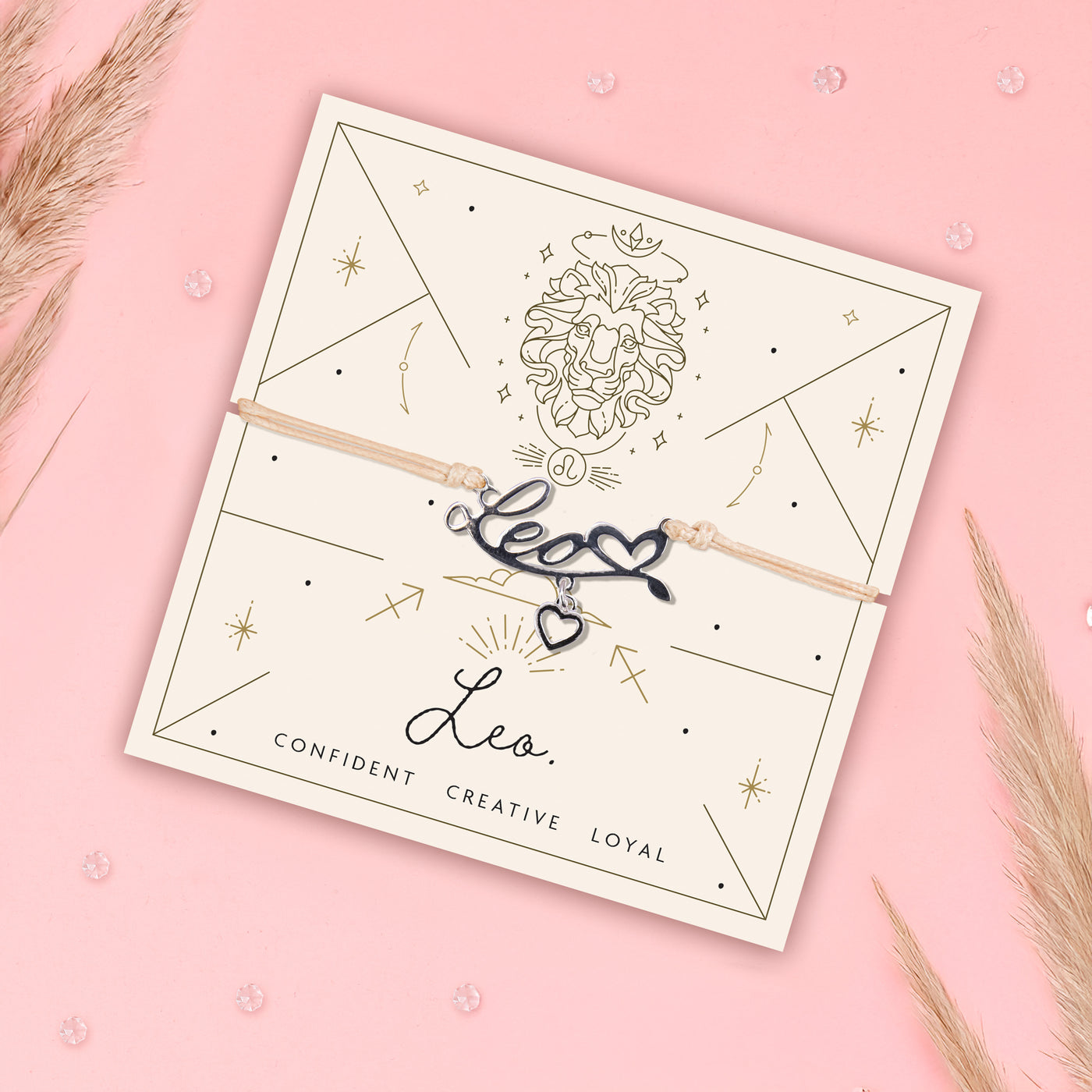 Bracelet with 'Leo' charm on a branded card against a pink background. Zodiac jewellery for women under £20