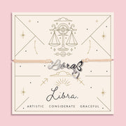 Libra zodiac sign charm on a pink background with decorative text and symbols. Affordable bracelet for a friend. Star sign presents under £20