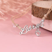 Silver 'Libra' necklace with a heart pendant on a pink background. A meaningful zodiac bracelet gift for her. Star sign jewellery under £20