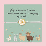 Bracelet with a daisy charm on a card featuring farm animals and text about enjoying life with animals. A cute gift for animal lovers.