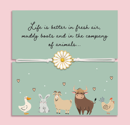 Bracelet with a daisy charm on a card featuring farm animals and text about enjoying life with animals. A cute gift for animal lovers.
