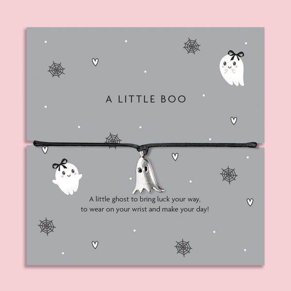 Silver ghost charm bracelet on black cord, displayed on grey Halloween-themed card with spiderweb and heart illustrations.