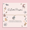 Adjustable beige cord bracelet with silver pumpkin pendant, displayed on blush autumn-themed card with pumpkins, candles, leaves, moon, and spider web illustrations. Perfect Halloween or autumn gift.