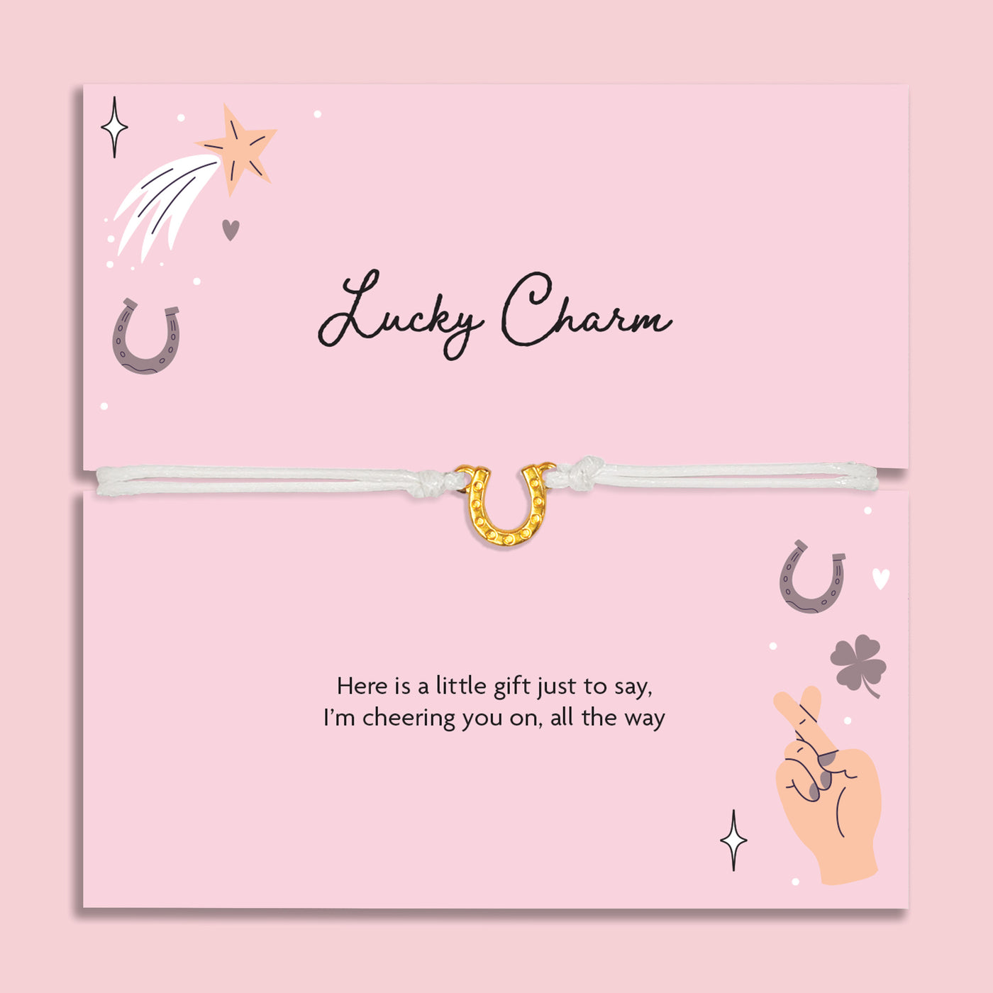 Lucky charm bracelet on a pink card with decorative elements and a horse shoe bracelet