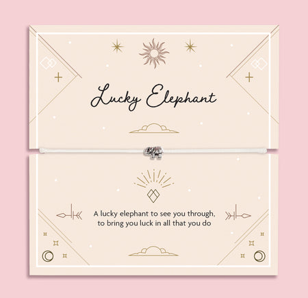 Lucky Elephant bracelet with silver elephant charm on an adjustable cord, displayed on a soft peach celestial poem card. A meaningful good luck gift for her.