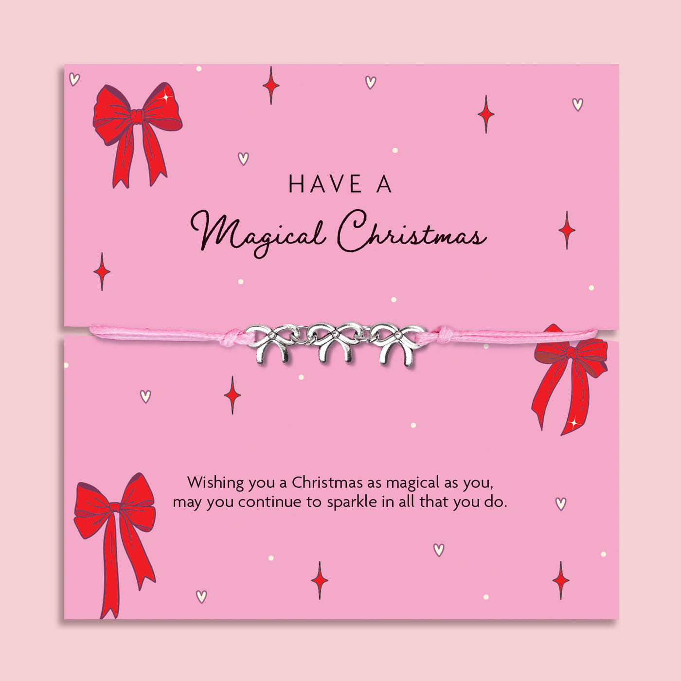 Pink Christmas card with red bows and decorative text on a pink background with a friendship bracelet with bow charms. A meaningful gift under £10 for Christmas.