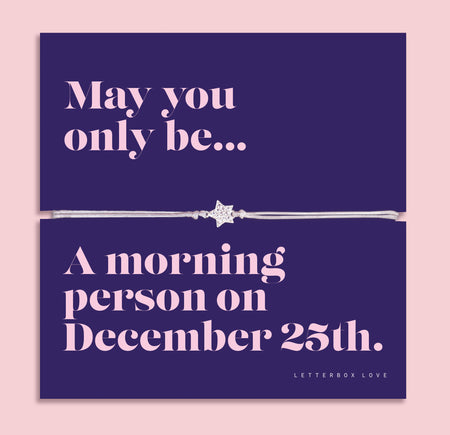 Christmas star bracelet featuring a sparkling cubic zirconia star charm on an adjustable bracelet, presented on a navy Christmas card with the playful message “May you only be a morning person on December 25th.” Includes a soft white pouch for gifting and safekeeping. A fun and thoughtful Christmas jewellery gift.