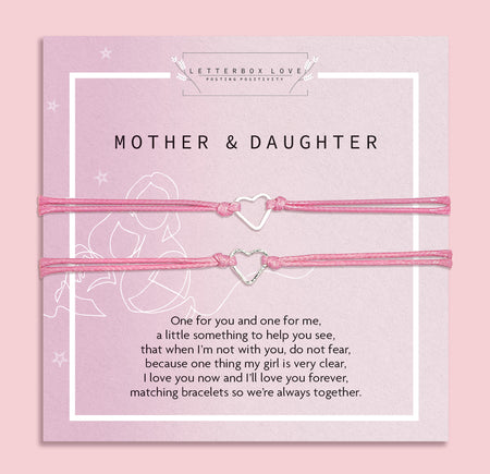 Two pink heart-shaped bracelets on a matching card with text, against a light pink background. A cute gift under £10 for a mother and daughter